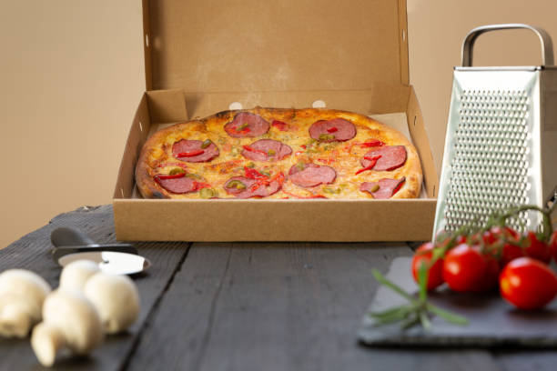 istock Hot pizza and ingredients on a black table 1271465140