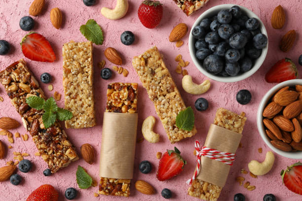 istock Granola bars and bowl with blueberry on pink background, top view 1271466953
