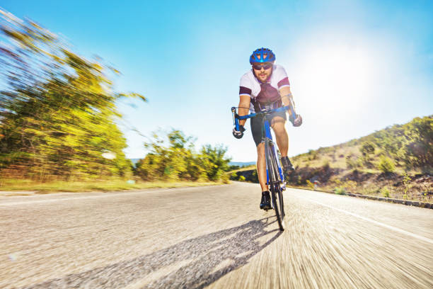 istock Male bicyclist riding on an open road 1271467036
