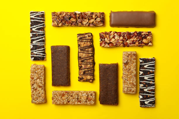 istock Flat lay with tasty granola bars yellow background, top view 1271467066