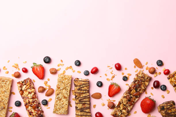 istock Tasty granola bars on pink background, top view 1271467346