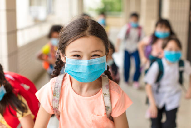 children wearing  face medical mask back to school after covid-19 quarantine children wearing  face medical mask back to school after covid-19 quarantine school children stock pictures, royalty-free photos & images