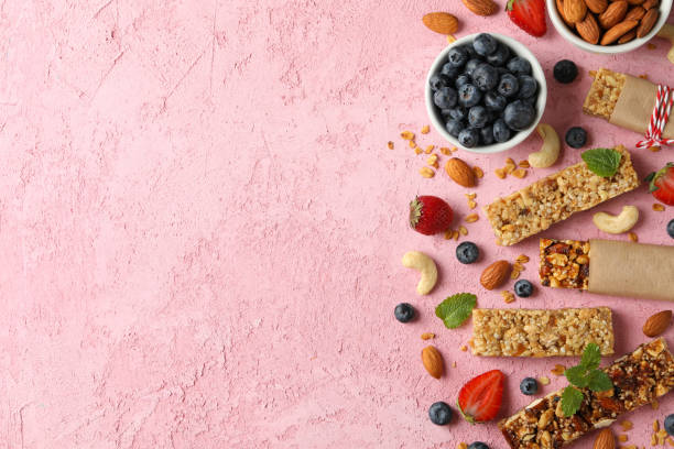 istock Granola bars and bowl with blueberry on pink background, top view 1271468495