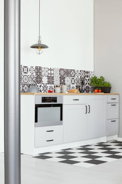 istock Trendy white kitchen interior with elegant wooden cupboards and kitchen accessories 1271468666