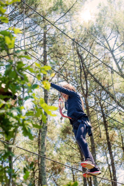 istock Pretty little girl in a tree climbing park 1271469422