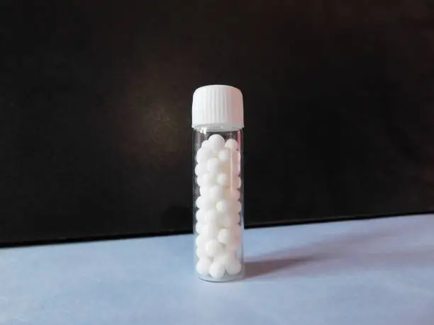 A bottle of Homeopathic medicine isolated on a surface