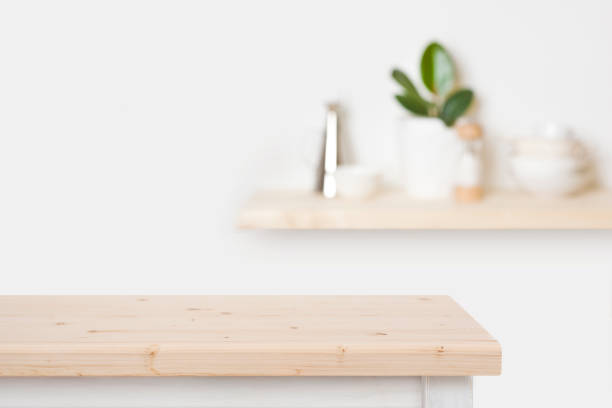 istock Natural wooden table top and blurred wall with kitchen shelf 1271470600