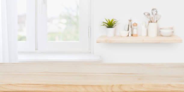 istock Blurred kitchen window background with wooden table for product display 1271470641
