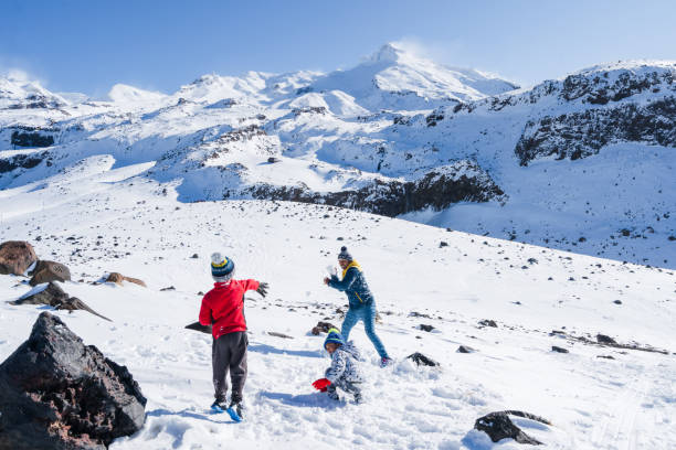istock Father with kids playing with snow. 1271471690