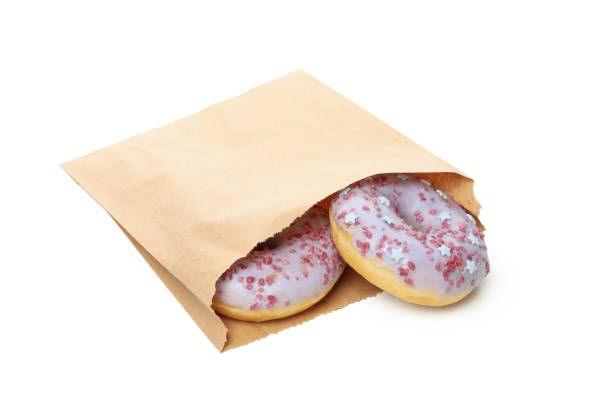 istock Paper bag with donuts isolated on white background 1271471933