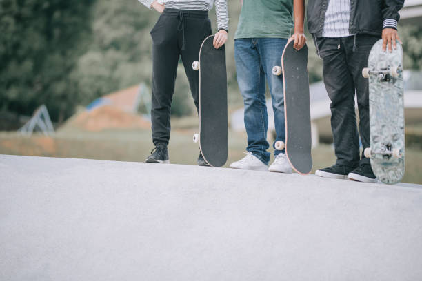 istock Asian skateboarders standing  at skateboard park 1271473201