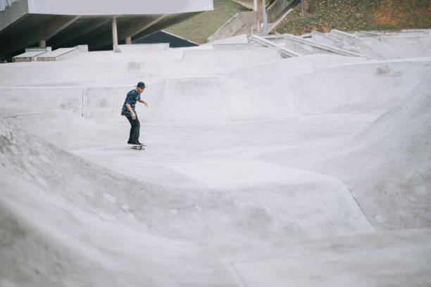 istock Asian skateboarder in action 1271473229