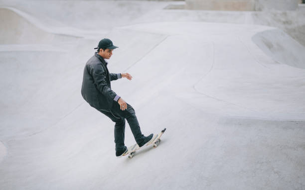 istock Asian skateboarder in action 1271473245