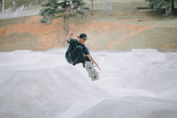 istock Asian skateboarder in action 1271473286