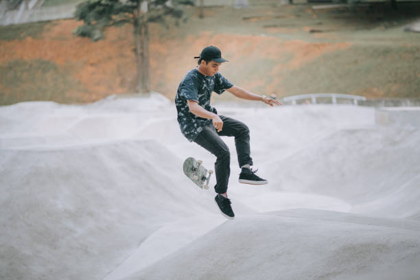 istock Asian skateboarder in action 1271473300