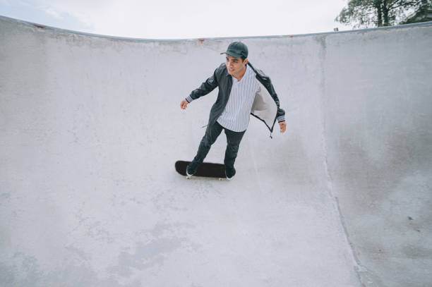 istock Asian skateboarder in action 1271473305