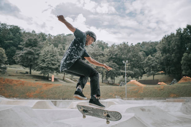 istock Asian skateboarder in action 1271473336