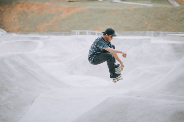 istock Asian skateboarder in action 1271473371