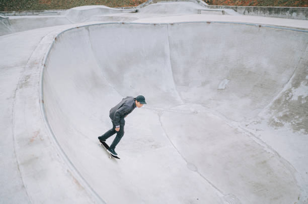 istock Asian skateboarder in action 1271473395