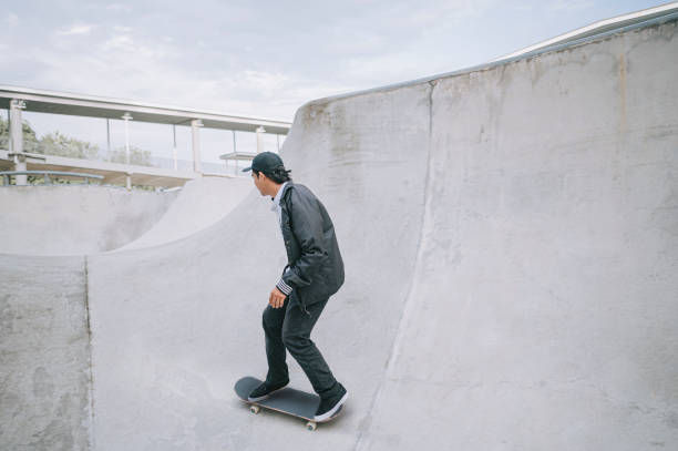 istock Asian skateboarder in action 1271473416