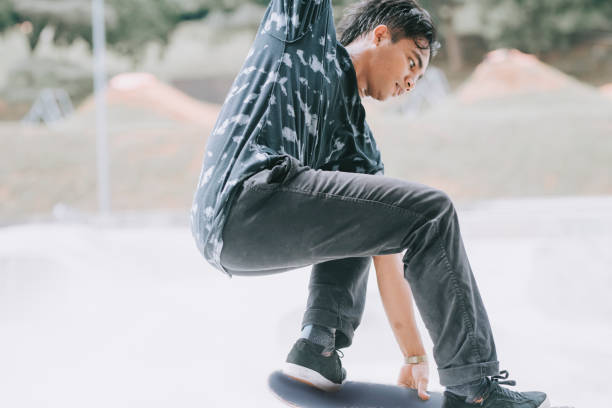 istock Asian skateboarder in action 1271473463