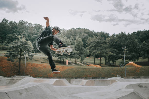 istock Asian skateboarder in action 1271473477