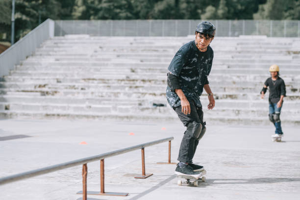 istock Asian skateboarder in action competing each other sliding railing 1271473497