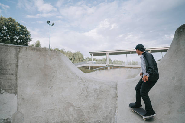 istock Asian skateboarder in action 1271474083