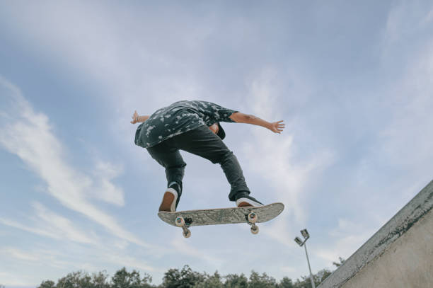 istock Asian skateboarder in action mid air 1271474102