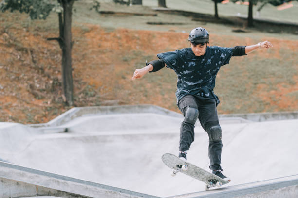 istock Asian skateboarder in action 1271474118