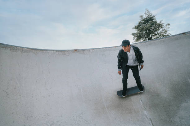 istock Asian skateboarder in action 1271474120