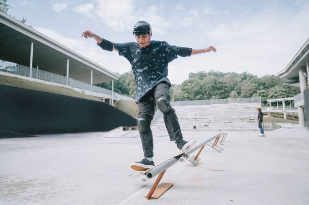 istock 2 Asian skateboarder in action 1271474121