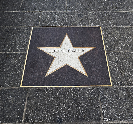 Bologna / Italy - September 8, 2020: Star on the floor in memory of the famous italian songwriter Lucio Dalla in a center street of Bologna.
