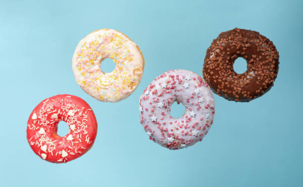 istock Four different tasty donuts on blue background 1271474347