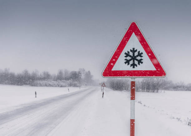 istock Snowy road with warning sign 1271475589