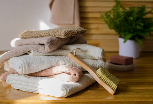 istock Stack of terry bath towels in different brown shades and washing accessories 1271477248