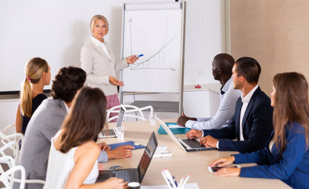 istock Woman reading out report to colleagues 1271479778
