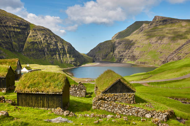 Picturesque green landscape with black houses in Faroe islands. Saksun Picturesque green landscape with wooden houses in Faroe islands. Saksun faroe islands photos stock pictures, royalty-free photos & images