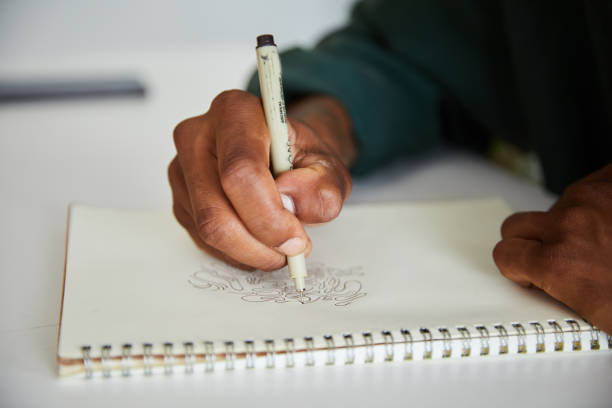 istock Young artist drawing a design in his sketchbook 1271481694