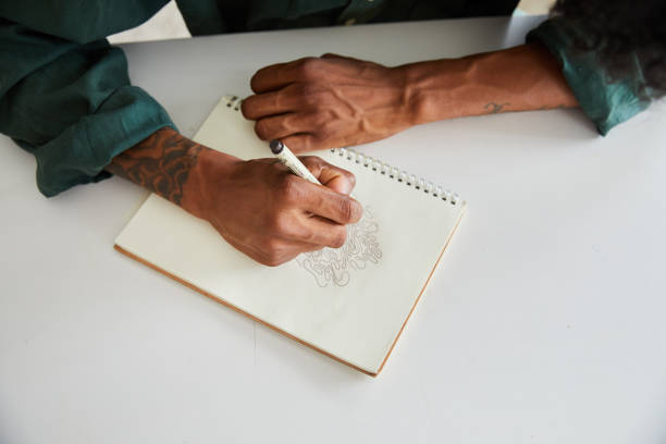 istock Young artist working on a drawing in his sketchbook 1271482663