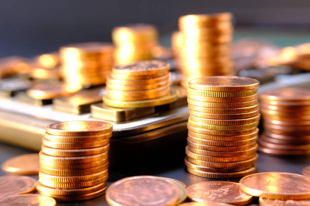 istock Close up of coins on black background 1271482665