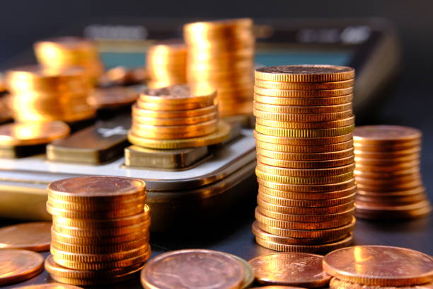 istock Close up of coins on black background 1271482680