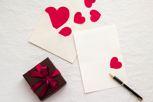 Image of a loving letter with cards and envelopes, hearts and gift boxes