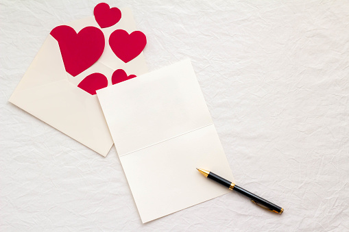 Image of a letter with a card and envelope, a heart's love