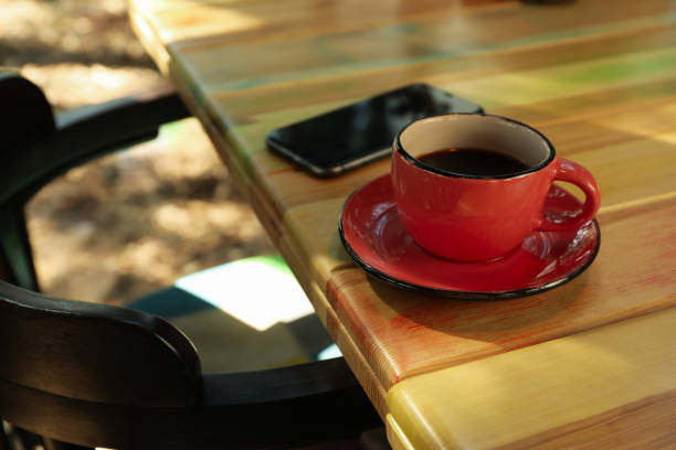 istock Phone and cup of coffee on wooden table 1271486519