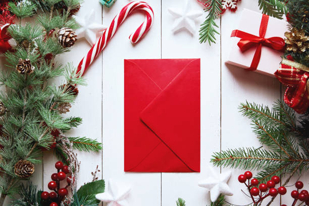 istock Christmas composition. Christmas gift, , pine cones, fir branches on wooden white background. Empty christmas card with envelope  Flat lay, top view, copy space. New Year. 1271487931
