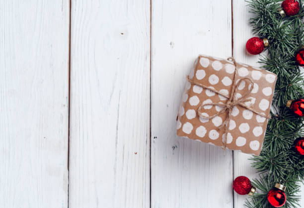 istock White wooden background with coniferous branches and Christmas decorations 1271489709