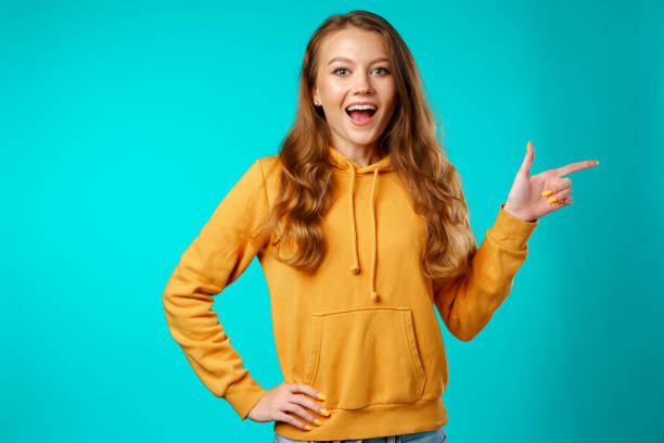 istock Portrait charming pretty cheerful girl showing copy space 1271489837