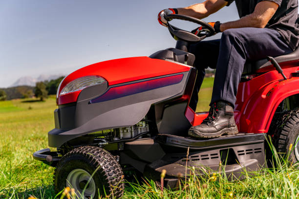 istock Young mandriving a tractor on a lawn 1271490357