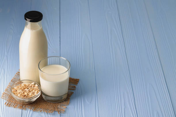 istock Vegan oat milk with oat flakes close up 1271491080